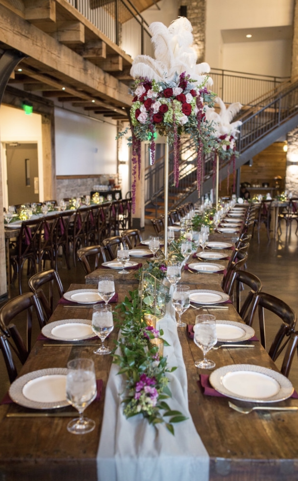 Wedding table scape. Long tables with flowers, plates and flatware